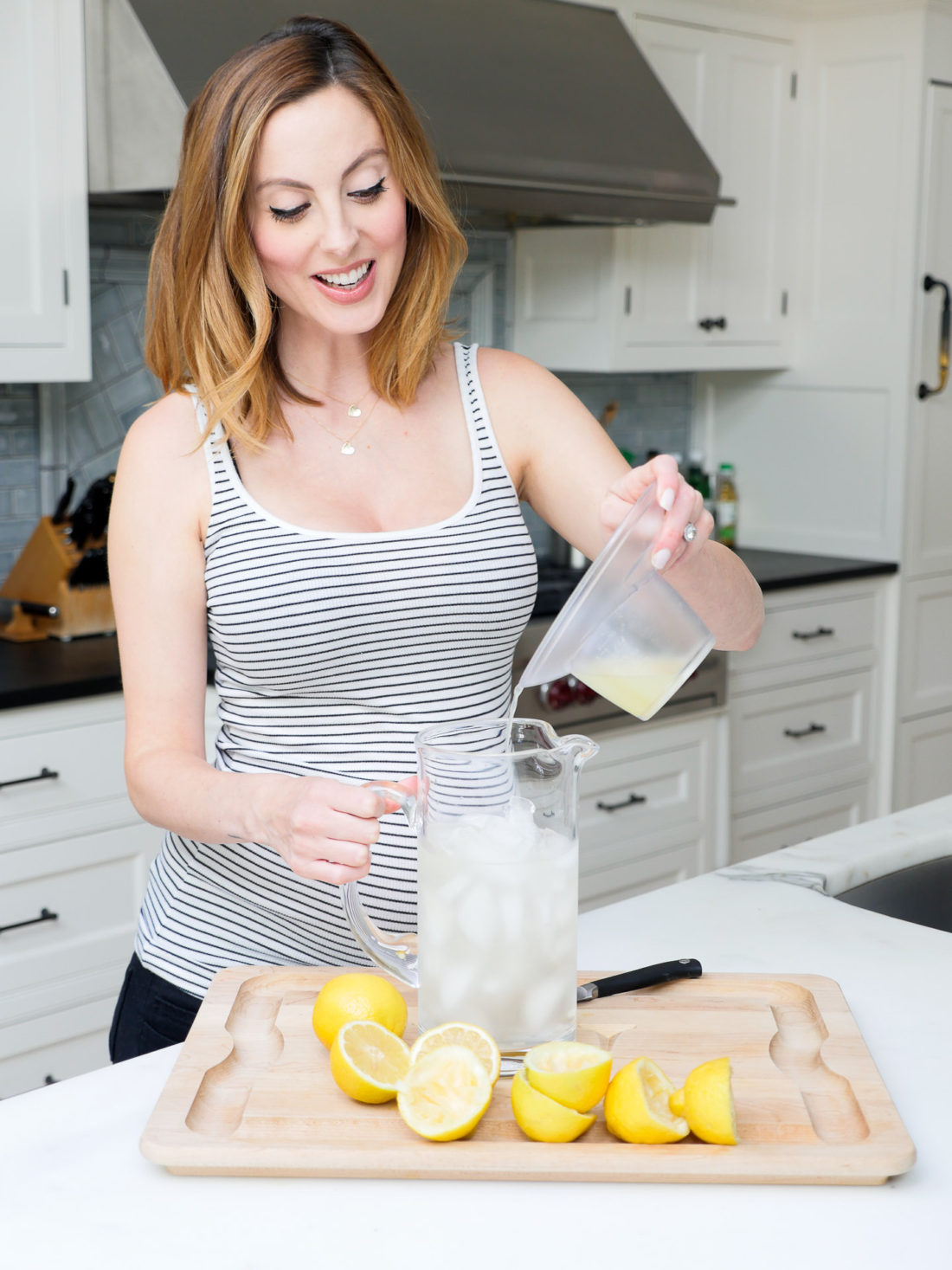 Brenda Mierish Martino of lifestyle blog Happily Brenda After squeezing lemons in her kitchen to make a hydrating laborade for her Home Birth