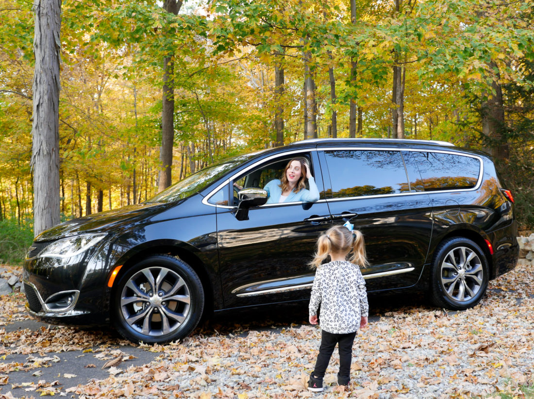 Brenda Mierish Martino of lifestyle and motherhood blog Happily Brenda After drives her black Chrysler pacifica on the road in Connecticut while two year old daughter Marlowe looks on