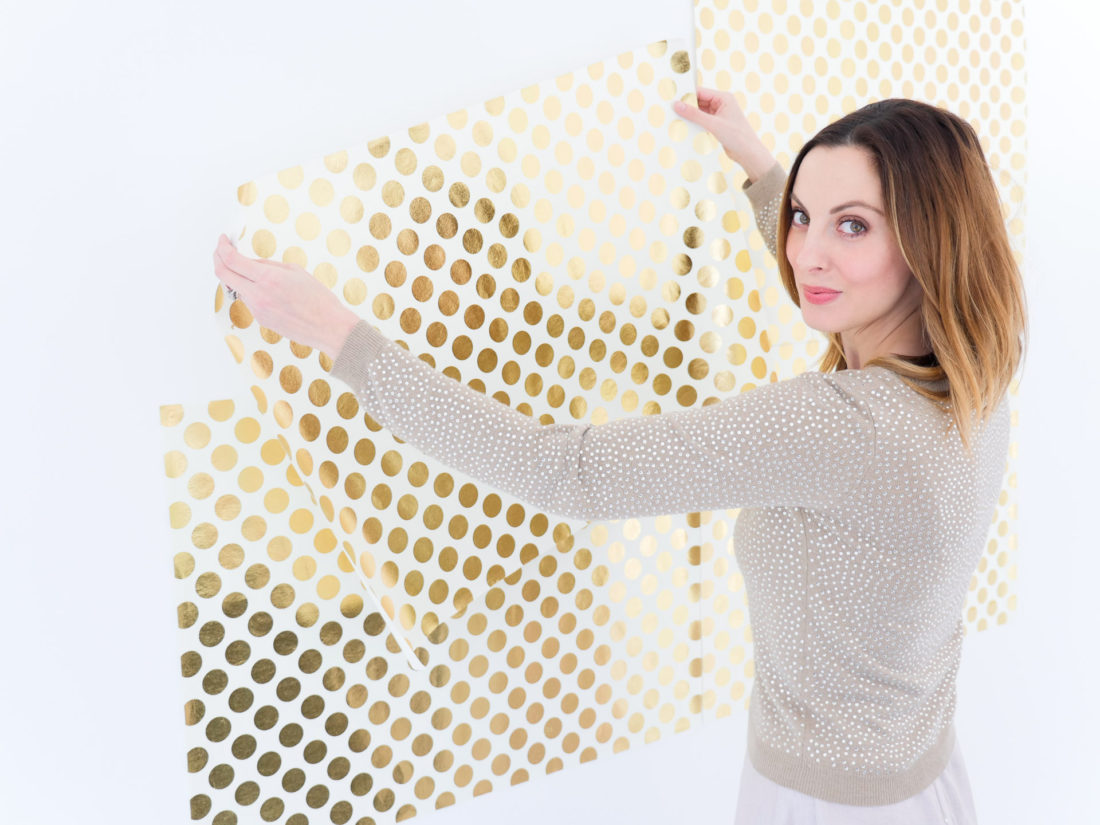 Brenda Mierish Martino of lifestyle and motherhood blog Happily Brenda After sets up a photo backdrop for her DIY Holiday Photo Place Cards project using the Instax mini 70