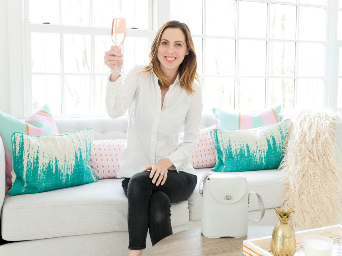 Brenda Mierish Martino of lifestyle and motherhood blog Happily Brenda After pictured in her studio with a glass of sparkling rose