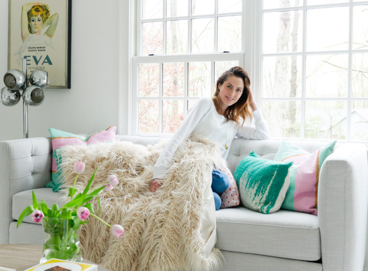 Brenda Mierish Martino relaxes on the couch in the Happily Brenda After studio wearing a white sweatshirt