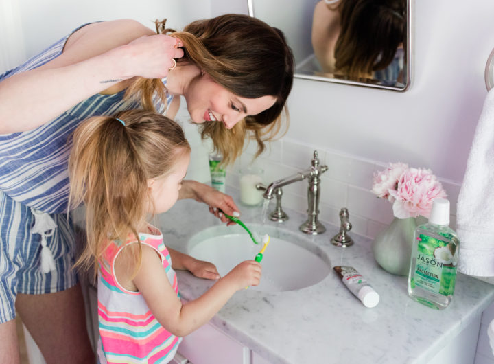 Brenda Mierish Martino wears a blue and white striped romper and brushes her teeth with two year old daughter, Marlowe, in the bathroom of their Connecticut home