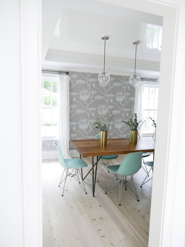 The modern and chic dining room in Brenda Mierish Martino's Connecticut home, featuring robins egg blue eames molded plastic eames chairs