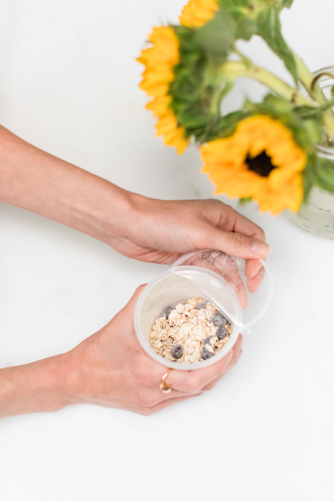 Brenda Mierish Martino peels back the plastic top of a container of Quaker Overnight Oats