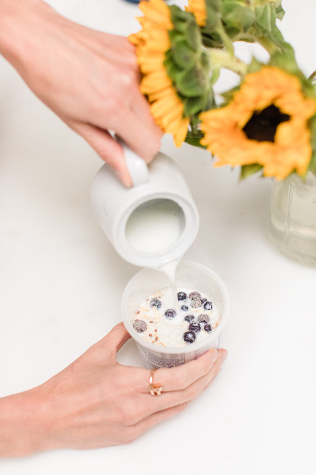Brenda Mierish Martino adds milk to a container of Quaker Overnight Oats