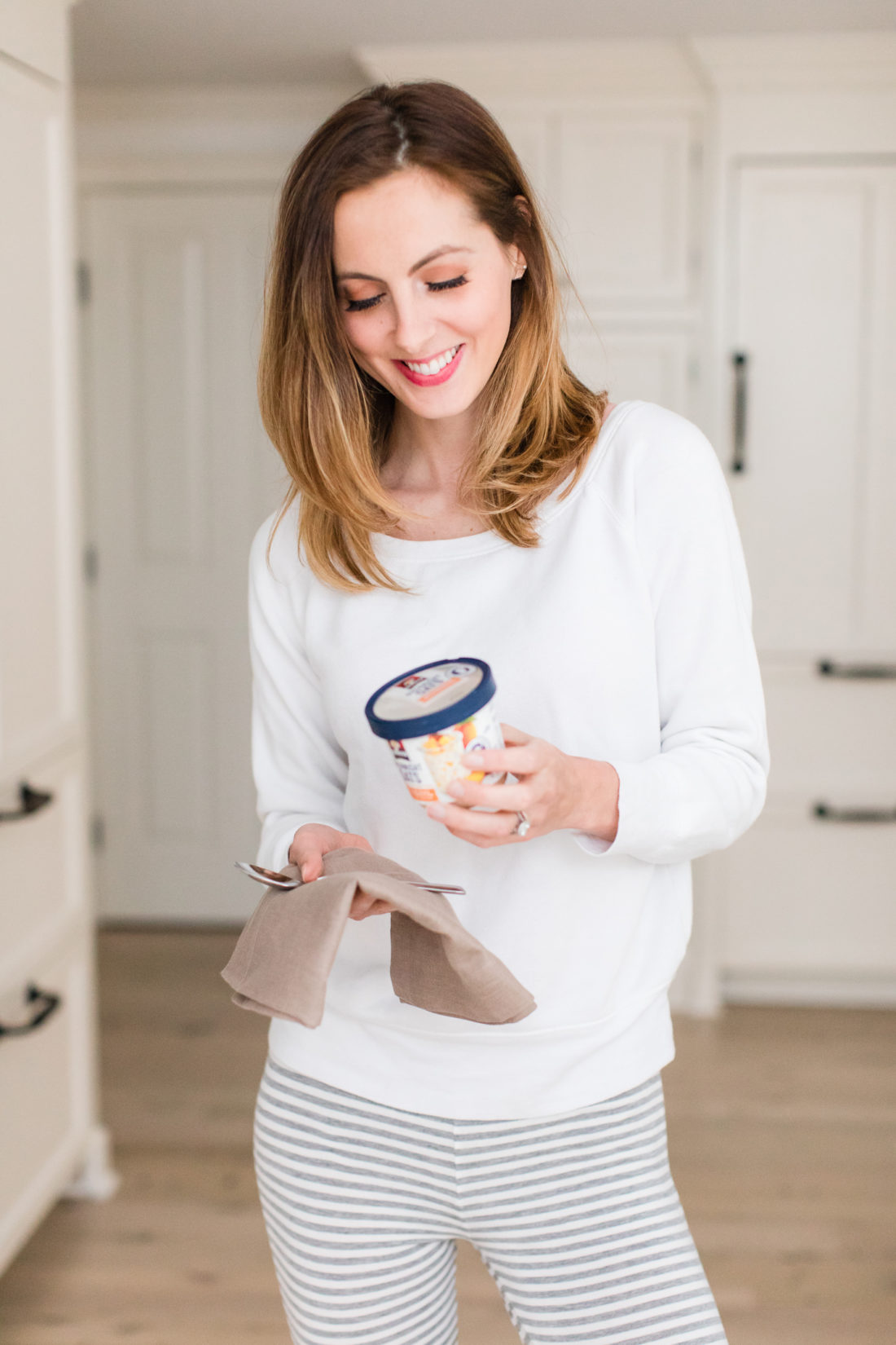 After steeping overnight, Brenda Mierish Martino wears pajamas and prepares to eat her Quaker Overnight Oats for breakfast