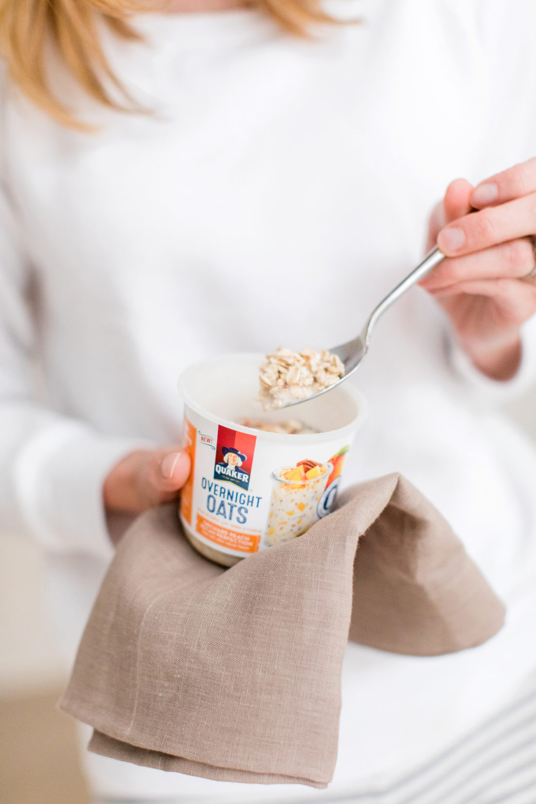 After steeping overnight, Brenda Mierish Martino wears pajamas and prepares to eat her Quaker Overnight Oats for breakfast