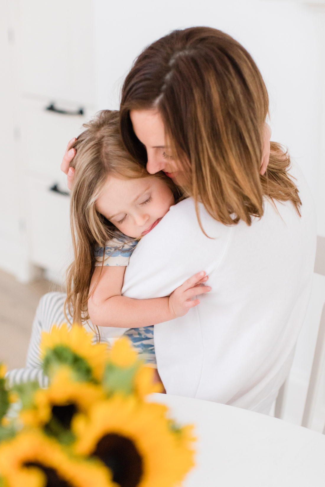 Brenda Mierish Martino snuggles with daughter Marlowe at the kitchen table of her Connecticut home
