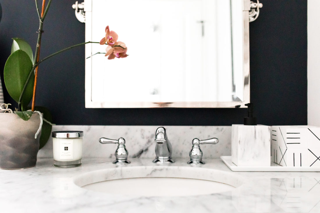 The faucet and marble vanity of Brenda Mierish Martino's powder room in her Connecticut home