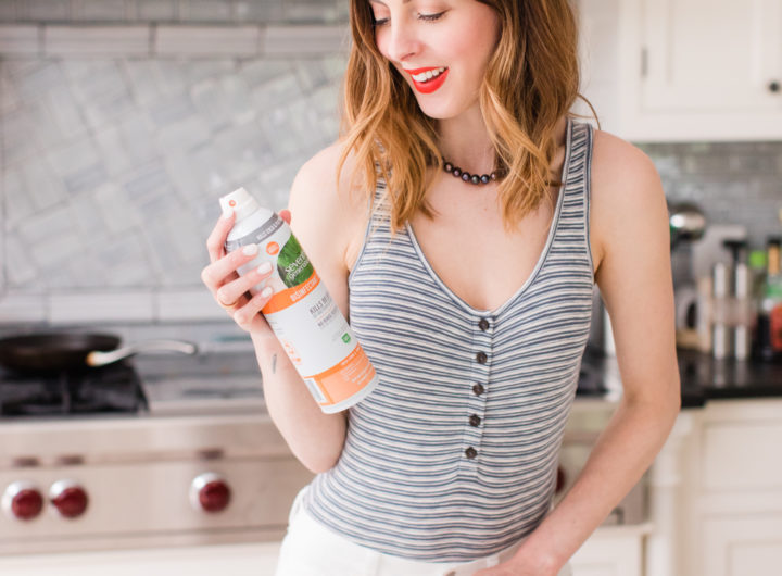 Brenda Mierish Martino wears a striped bodysuit and white jeans and cleans her connecticut kitchen with seventh generation spray