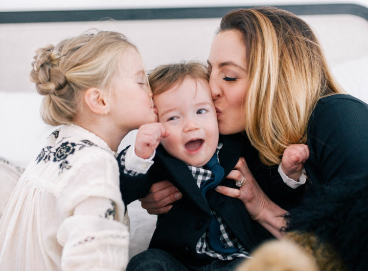 Brenda Mierish Martino and her daughter Marlowe Mae Martino kissing son Major James Martino on the bed in their Connecticut home.