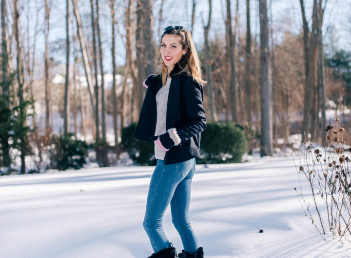 Brenda Mierish Martino stands in the snow outside her Connecticut home wearing blue jeans, a sweater, navy pea coat, and black snow boots