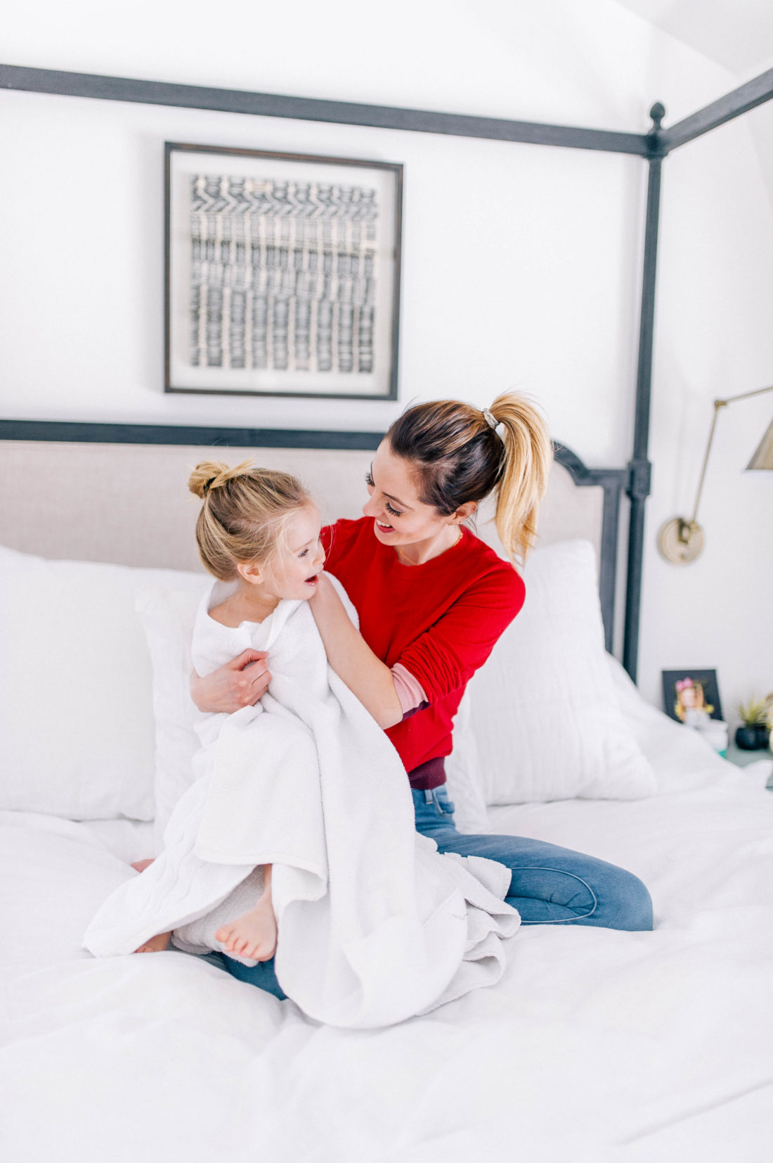 Brenda Mierish Martino wraps daughter Marlowe in a white towel in the bedroom of her Connecticut home