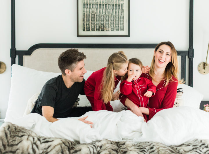 Brenda Mierish martino, Kyle Martino, and children Marlowe and Major Martino cuddle in bed wearing red pajamas for Valentine's Day in the master bedroom of their Connecticut home