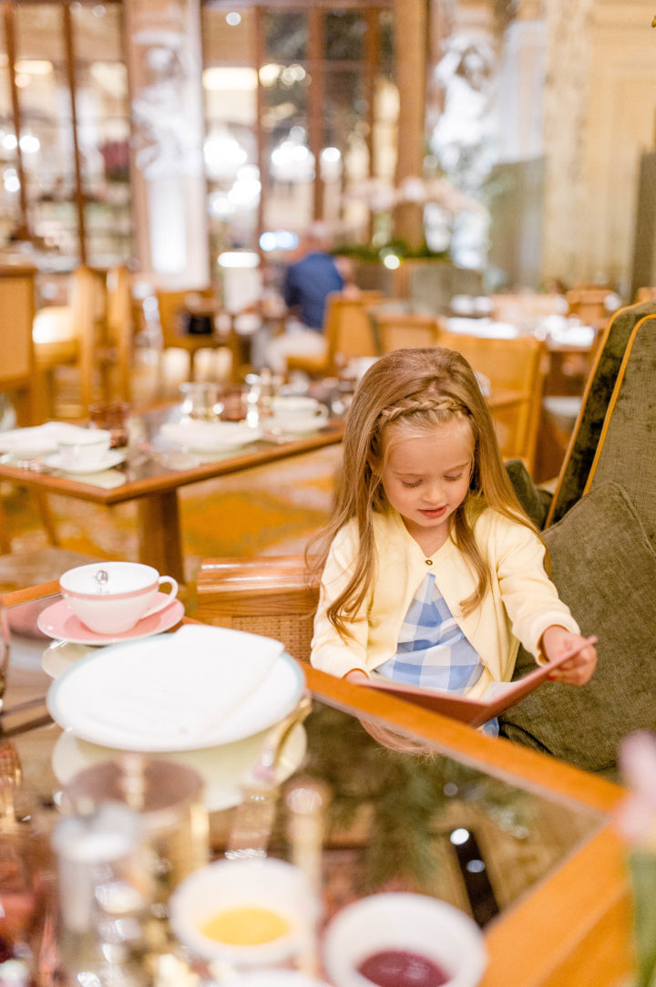 Brenda Mierish Martino's daughter Marlowe mulls over the menu at the iconic Plaza Hotel in New York City