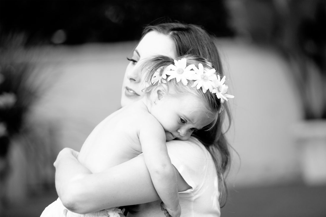 Brenda Mierish Martino holds toddler daughter Marlowe in her arms in the yard of their sherman oaks home