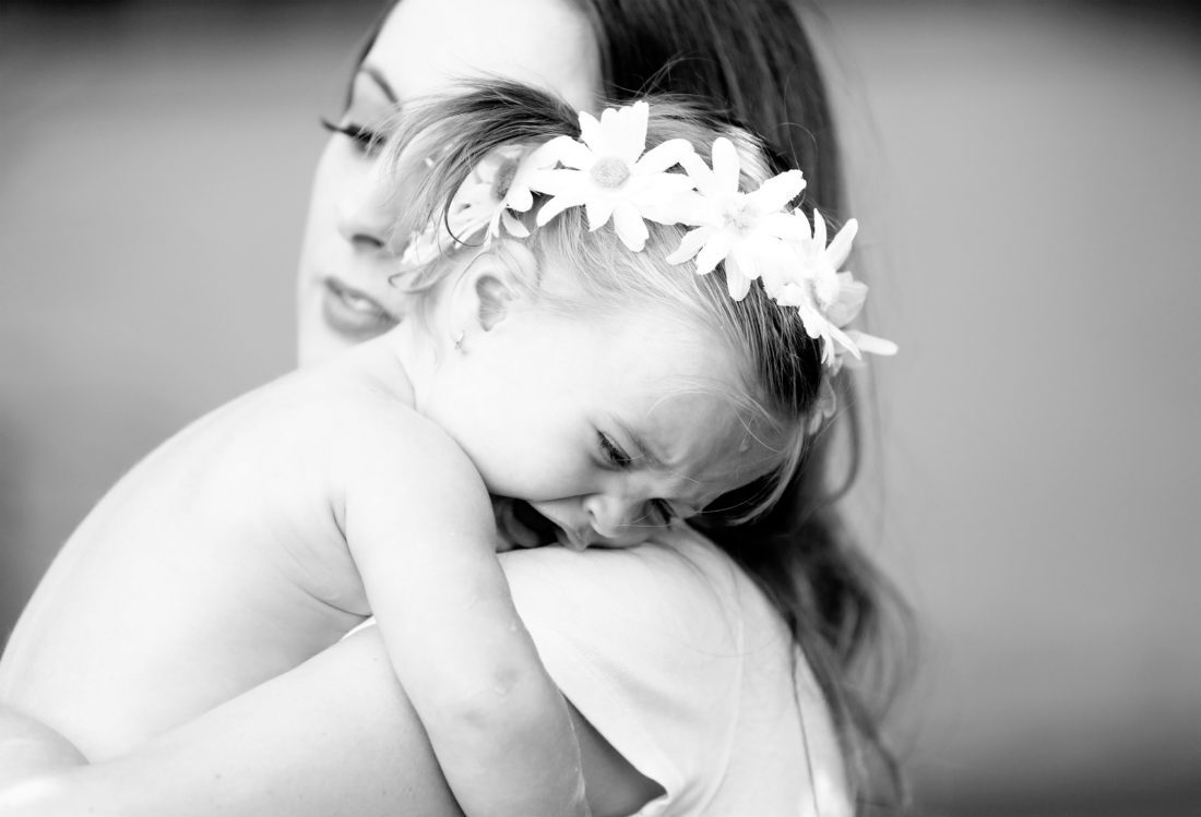 Brenda Mierish Martino holds toddler daughter Marlowe in her arms in the yard of their sherman oaks home