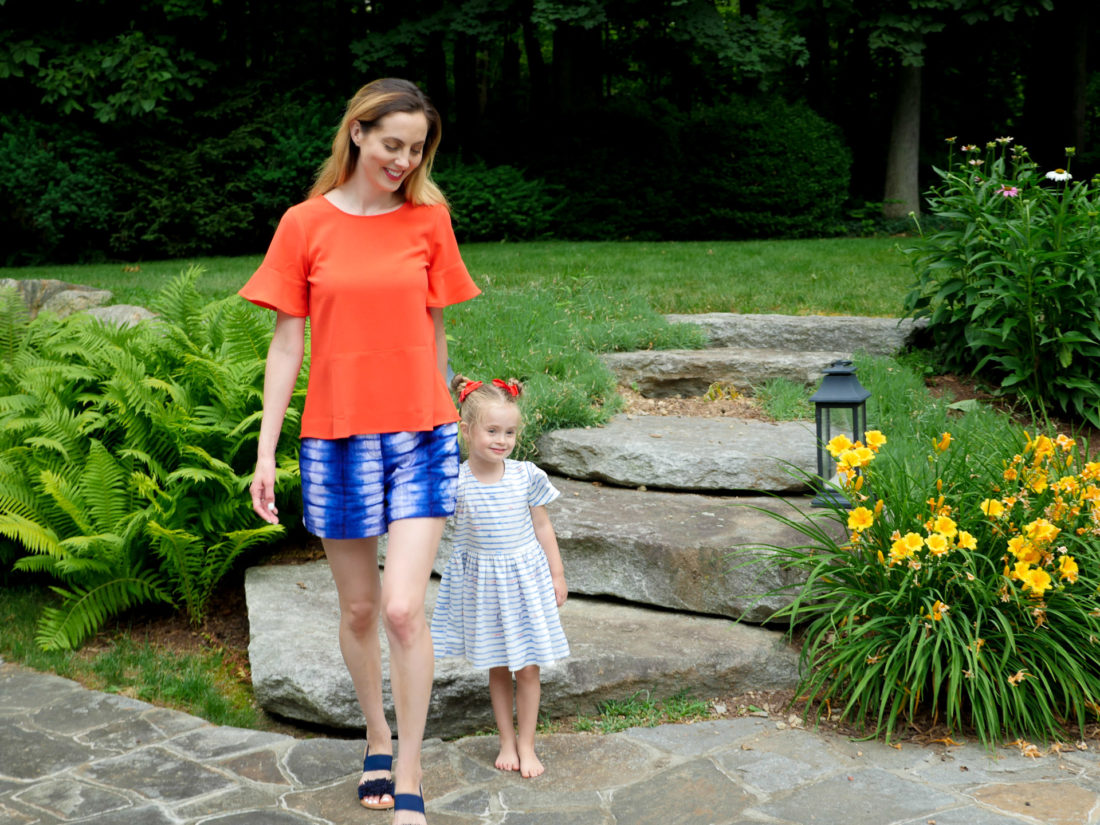 Brenda and Marlowe Martino walk through their backyard wearing red white and blue on the fourth of july