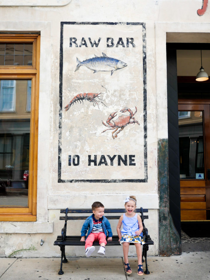 Brenda Mierish Martino's kids Marlowe and Major sit outside of a raw bar in Charleston