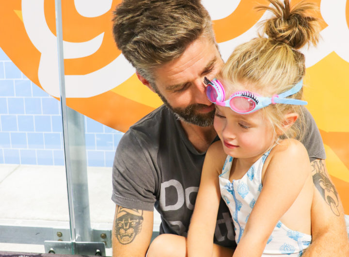 Kyle Martino holds daughter Marlowe before she has swim lessons at Goldfish Swim School